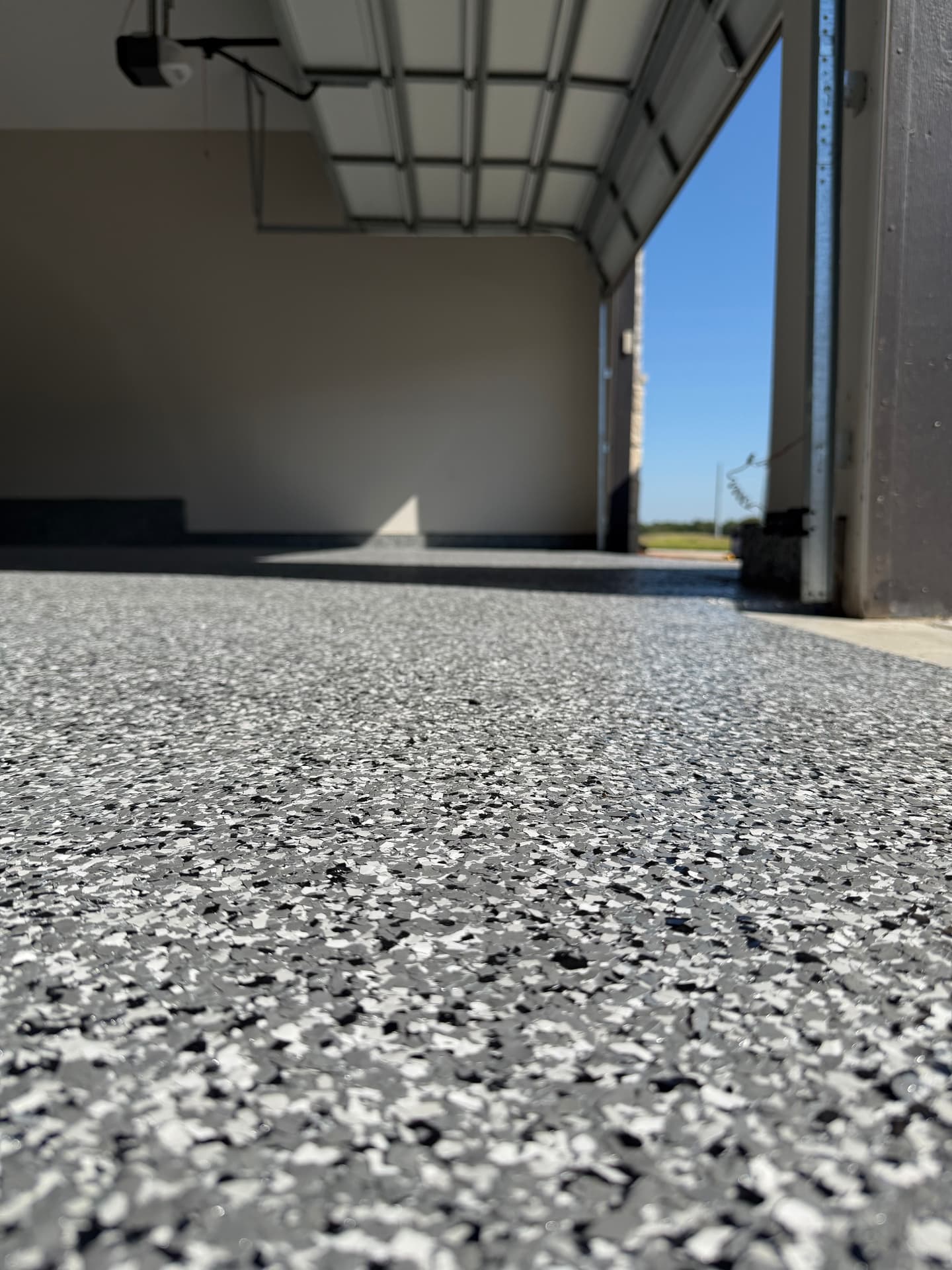 Low angle of finished flake epoxy garage floor in sunlight