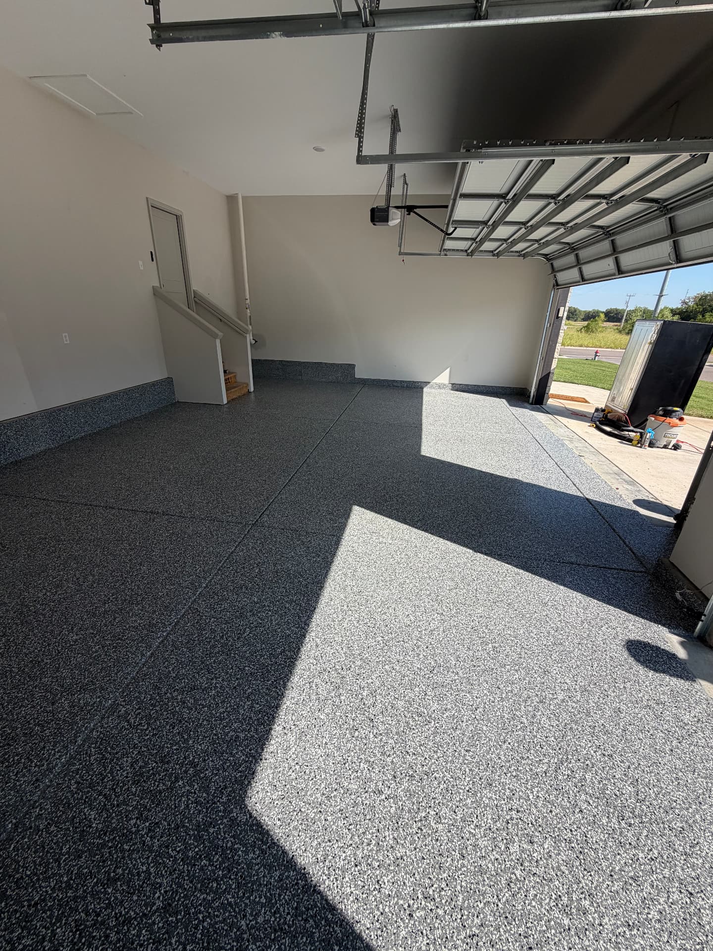 Two-car garage with flake epoxy floor and coated base trim