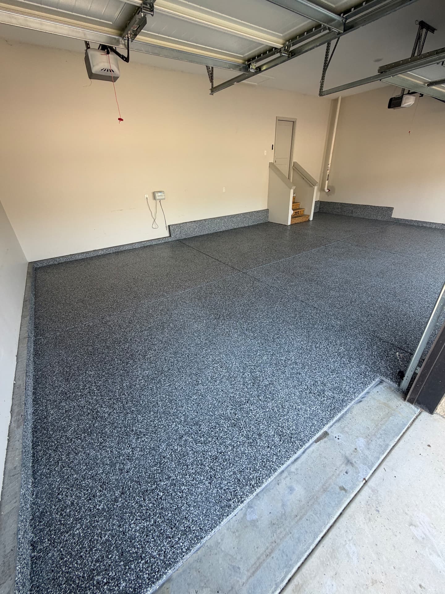 Grey and black flake epoxy garage floor with coated step, Wichita KS
